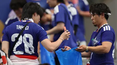 Japanese fans praised for stadium clean‑ups, but women call for men to pitch in at home